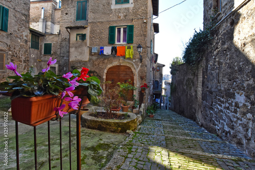 Fototapeta Naklejka Na Ścianę i Meble -  Anagni, Italy, A narrow street between the old stone houses of a medieval village.
