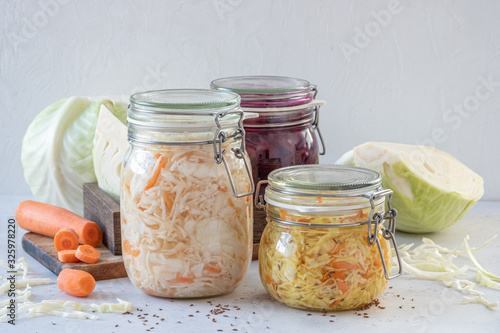 Fermented preserved vegetarian food concept. Cabbage sauerkraut sour glass jars photo