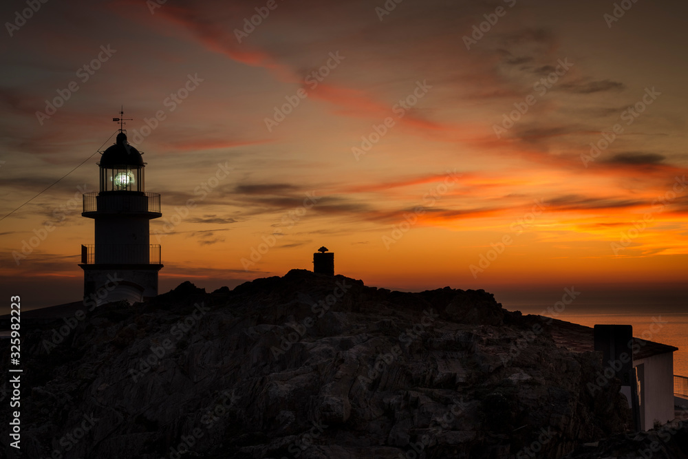 A sky with orange tones can be observed in the moments before sunrise. It is the Lighthouse of Cabo de Creus in Catalunya, Spain.