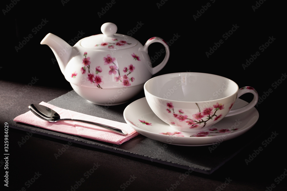 Cup of Tea and Teapot on the slate plate on the table Cup of Tea and Teapot on the slate plate on the table