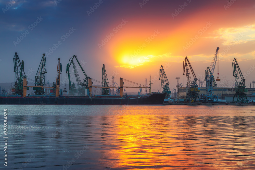 Sea port and industrial cranes, Varna, Bulgaria.Sunset over the Varna lake