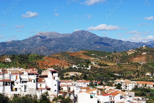 View over town rooftops towards the mountains, Guaro, Spain. © arenaphotouk