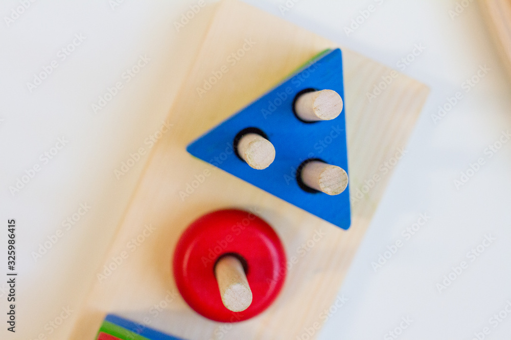 Naklejka premium concept of early childhood development using the Montessori method. children's toys made of wood. The Montessori Material. School and kindergarten. sorter. Logical educational toys.