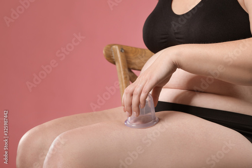 Overweight woman with cup f...