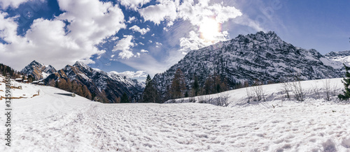 Panoramic view in the snowy mountains of Valsesia taken from the Otro valley, during a sunny day near the town of Alagna, Italy - February 2020. photo