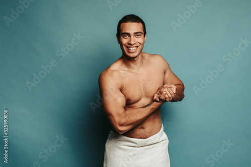 Photography Hot sporty young arabian man show his muscles on forearms and pose on camera