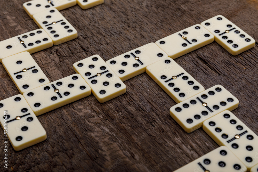 Dominoes game on old rustic wooden background. The concept of the game  dominoes. Photos | Adobe Stock