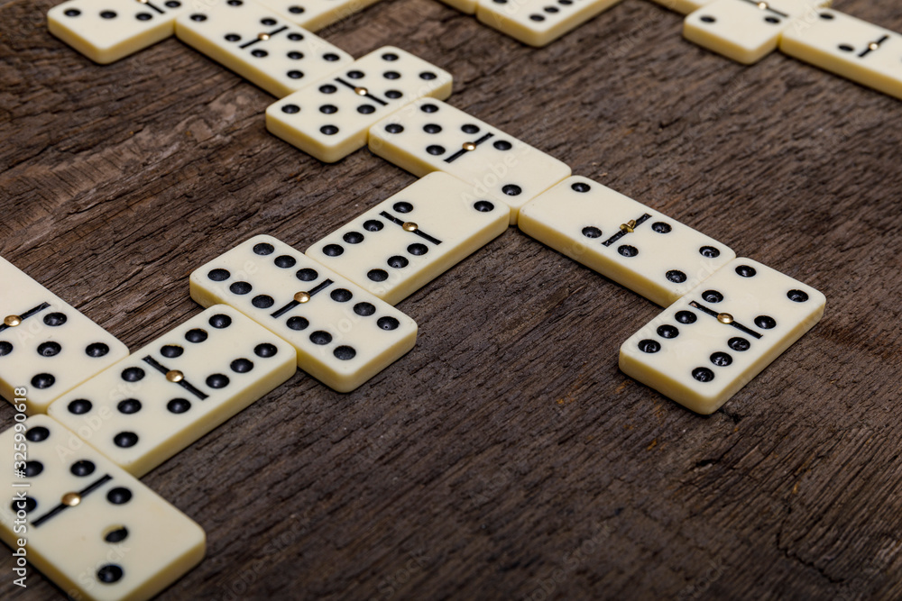 Dominoes game on old rustic wooden background. The concept of the game dominoes. Dominoes game on old rustic wooden background. The concept of the game dominoes.