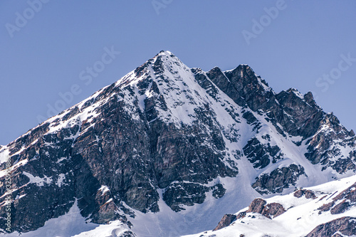 The snowy mountains of Valsesia seen from the val d otro  during a sunny day near the town of Alagna  Italy - February 2020.