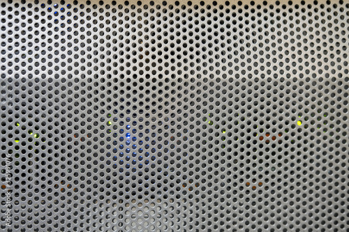 Background of a convex metal surface with round lattice holes  texture  copy space