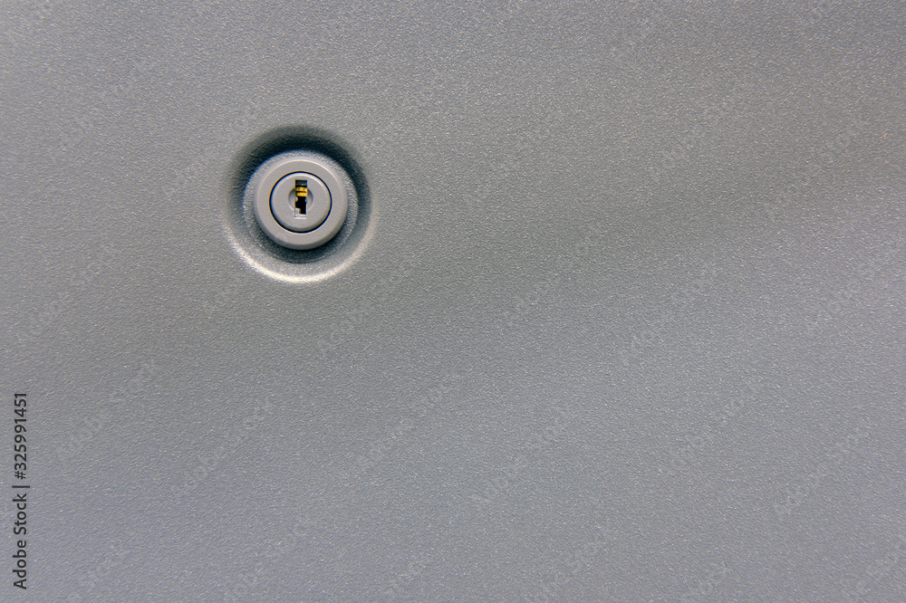 Background of a metal surface with a key lock, copy space Background of a metal surface with a key lock, copy space