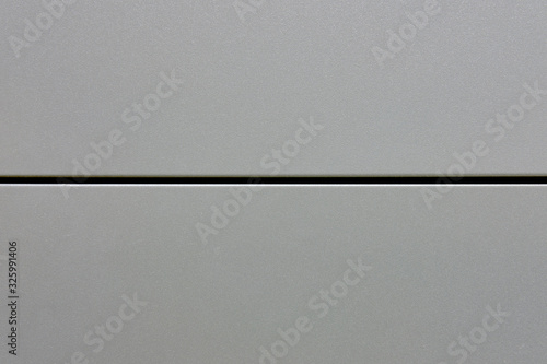 Background metal plate of two halves, copy space. The surface texture of the steel divided in half.