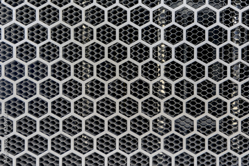 Metal background with hexagon holes perforation, net of circles texture