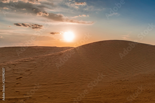 evening setting sun over the sand dunes in the Sahara desert