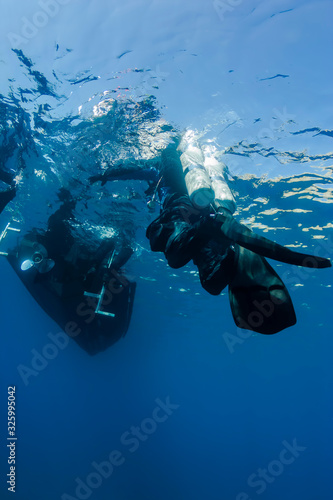Technical diver reaching boat after deep dive