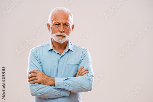 Portrait of pensive and serious senior man. © djoronimo