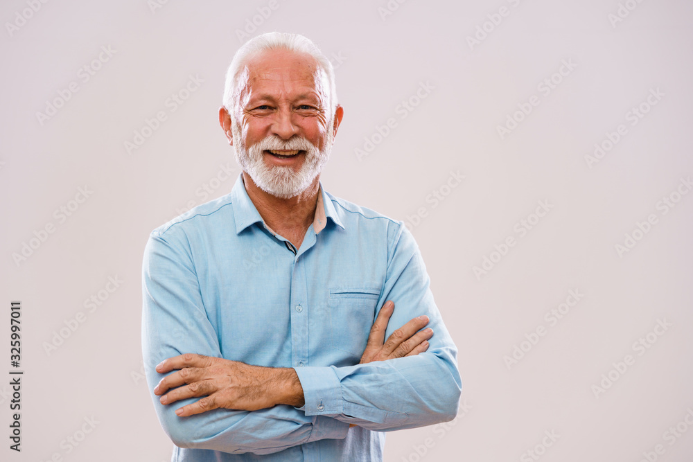 Portrait of cheerful senior man who is looking at camera and smiling. - obrazy, fototapety, plakaty 