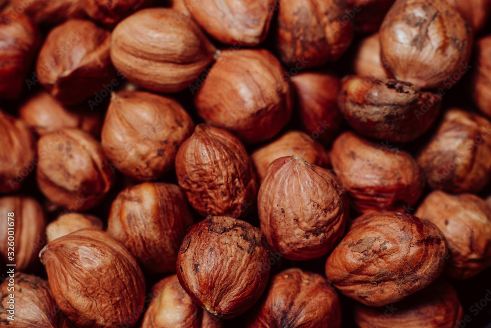 Purified hazelnuts on market counter in daylight. Fresh nuts in macro photo. Close up. Top view. Purified hazelnuts on market counter in daylight. Fresh nuts in macro photo. Close up. Top view.