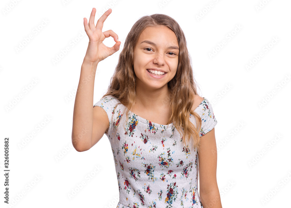 Portrait of teen girl making Ok Gesture, isolated on white background. Beautiful caucasian young teenager smiling and giving OK sign. Happy cute child showing okay. Portrait of teen girl making Ok Gesture, isolated on white background. Beautiful caucasian young teenager smiling and giving OK sign. Happy cute child showing okay.