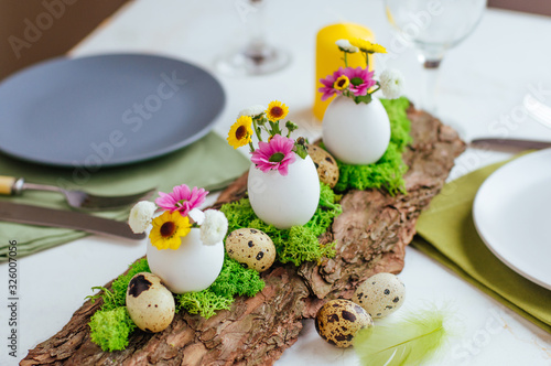 Natural decoration for Easter serving table with eggs and flowers © lithiumphoto