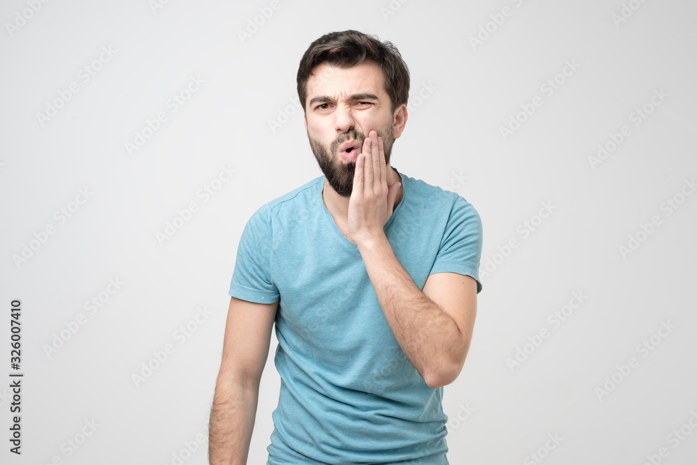 Guy wearing blue shirt with tooth ache isolated on white background Guy wearing blue shirt with tooth ache isolated on white background