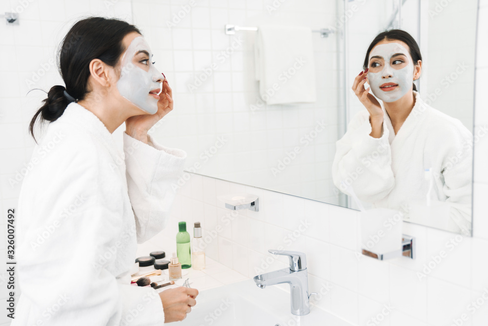 Optimistic young woman take care of skin Optimistic young woman take care of skin