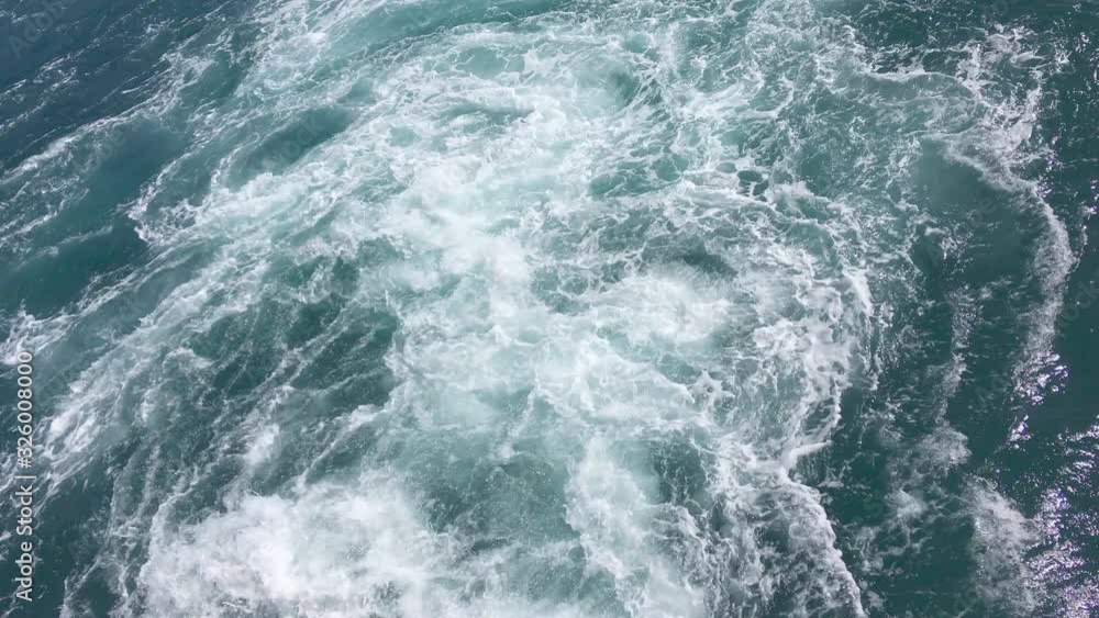 Wake behind big ferry. Turbulent water caused by ferry and its propeller Wake behind big ferry. Turbulent water caused by ferry and its propeller