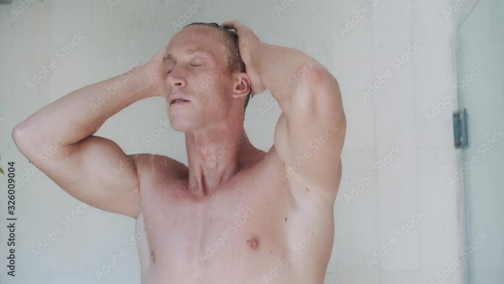attractive man takes refreshing shower in modern cabin attractive man takes refreshing shower in modern cabin