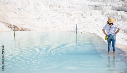 A lady in blue jeans standing at Pamukkale thermal bath, natural site in Denizli Province in southwestern Turkey