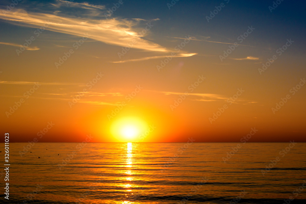 beautifun sunset on the beach with calm sea