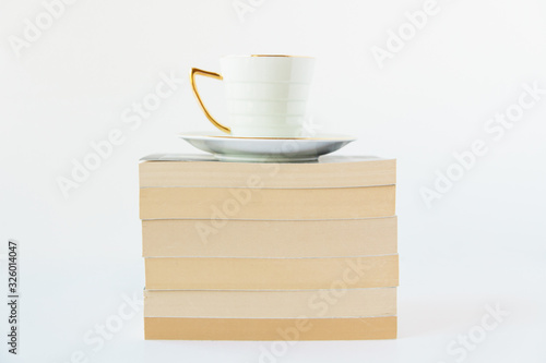 A cup of drink and stack of books.White background.Copy space.