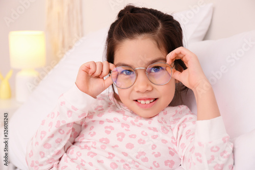 Cute little girl with glass...