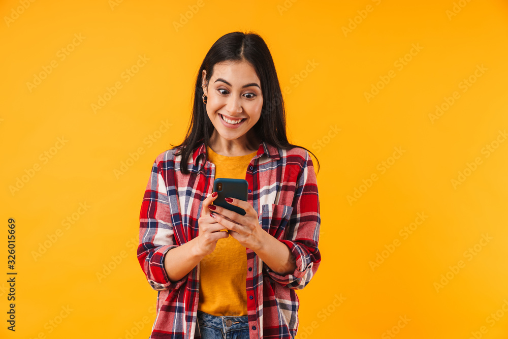 Image of excited attractive woman smiling and typing on cellphone Image of excited attractive woman smiling and typing on cellphone