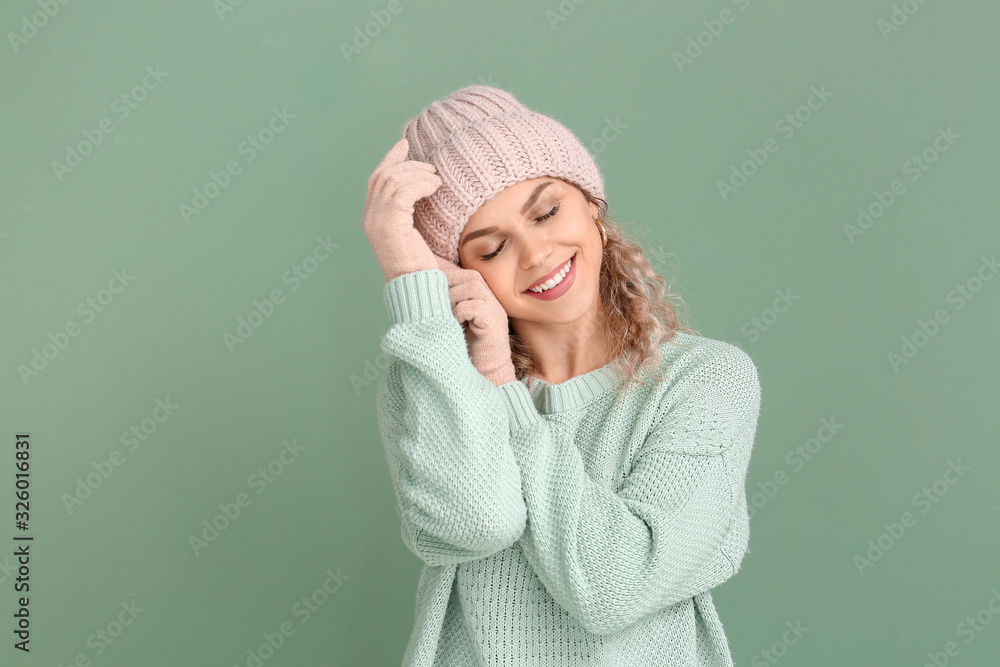 Beautiful young woman in warm sweater on color background Beautiful young woman in warm sweater on color background