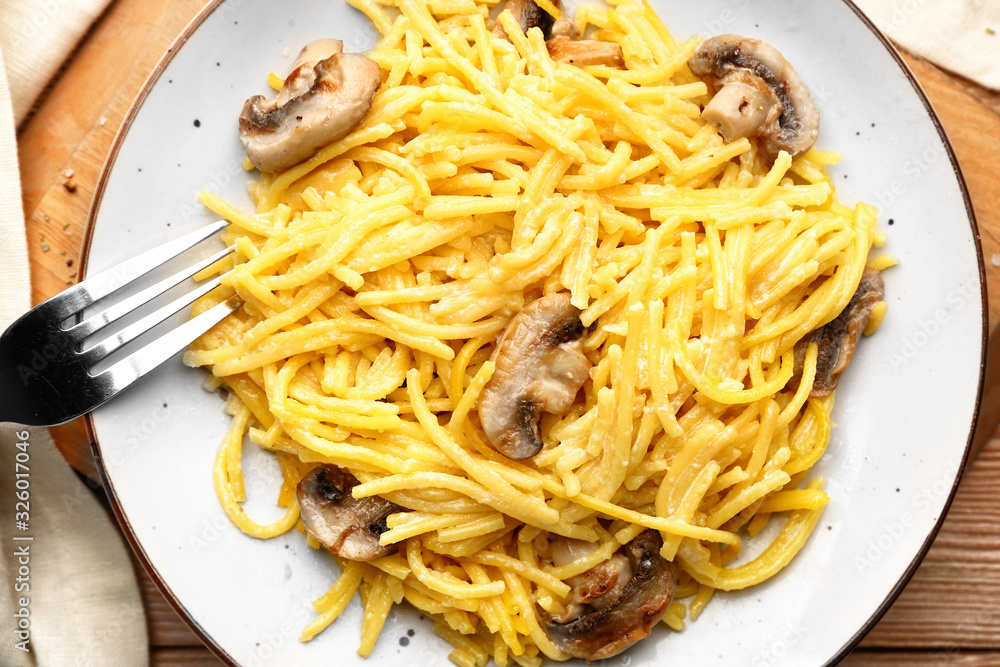 Plate with tasty pasta and mushrooms on table Plate with tasty pasta and mushrooms on table