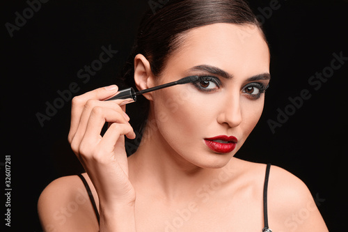 Glamorous Woman Applying Ma...