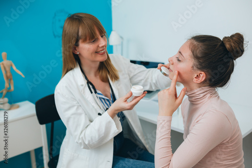 teenager girl at the dermatologist doctor