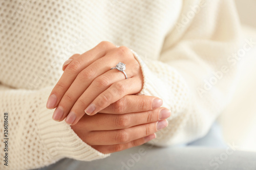 Young woman wearing beautiful engagement ring  closeup