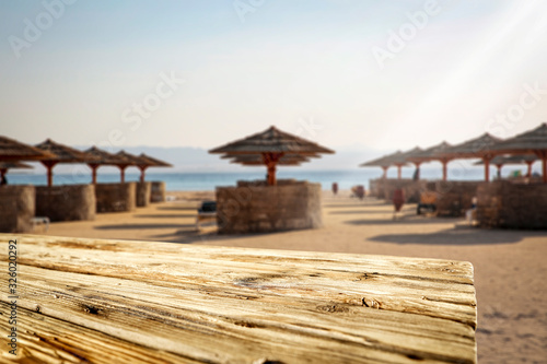 Wooden desk of free space and summer beach landscape. 