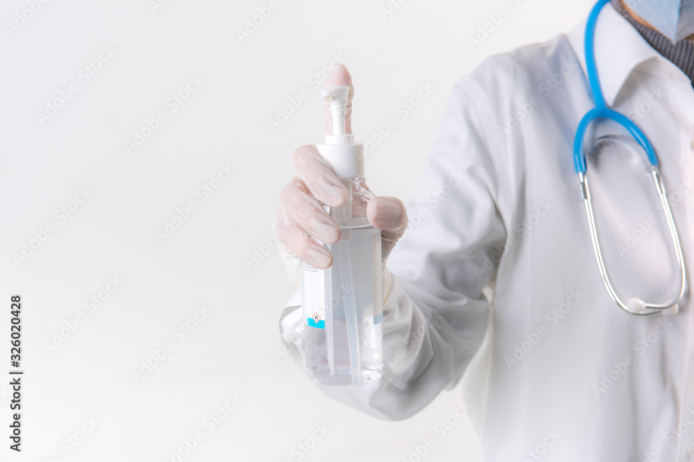 Fototapeta premium Doctor hands using washing hand with Alcohol Sanitizer isolate on a white background. Promoting people use face mask to protect themselves from virus infection in Corona virus crisis 2020
