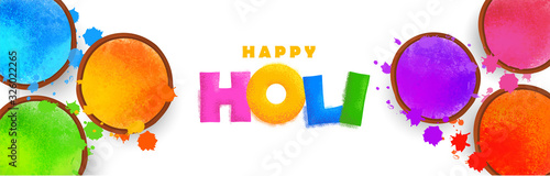 Happy holi celebration background. Colorful holi powder (gulal) and holi creative text on white background. Vector illustration. photo