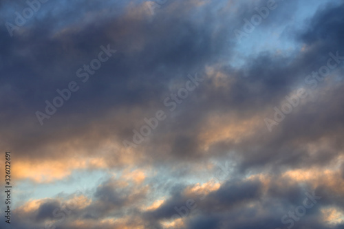 Sky background with dense clouds lit by the sun. © Na-um