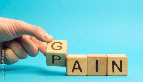 фотографія Wooden blocks with the words Gain, pain