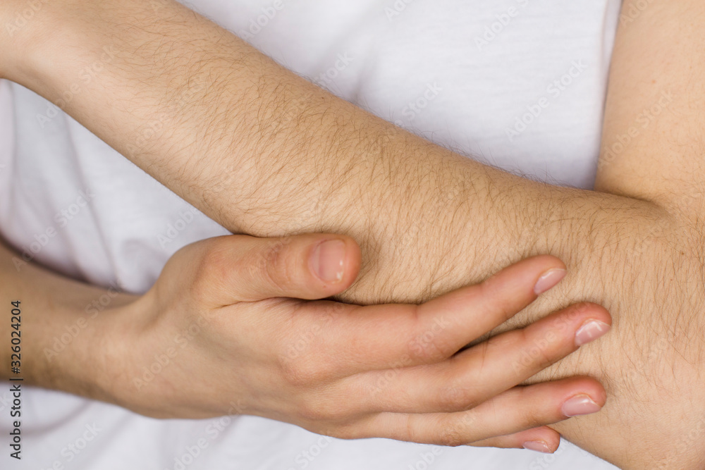 young woman in white shirt touching her hand. female hand hair young woman in white shirt touching her hand. female hand hair