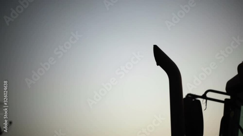 Exhaust pipe pollution of a truck bulldozer, medium shot