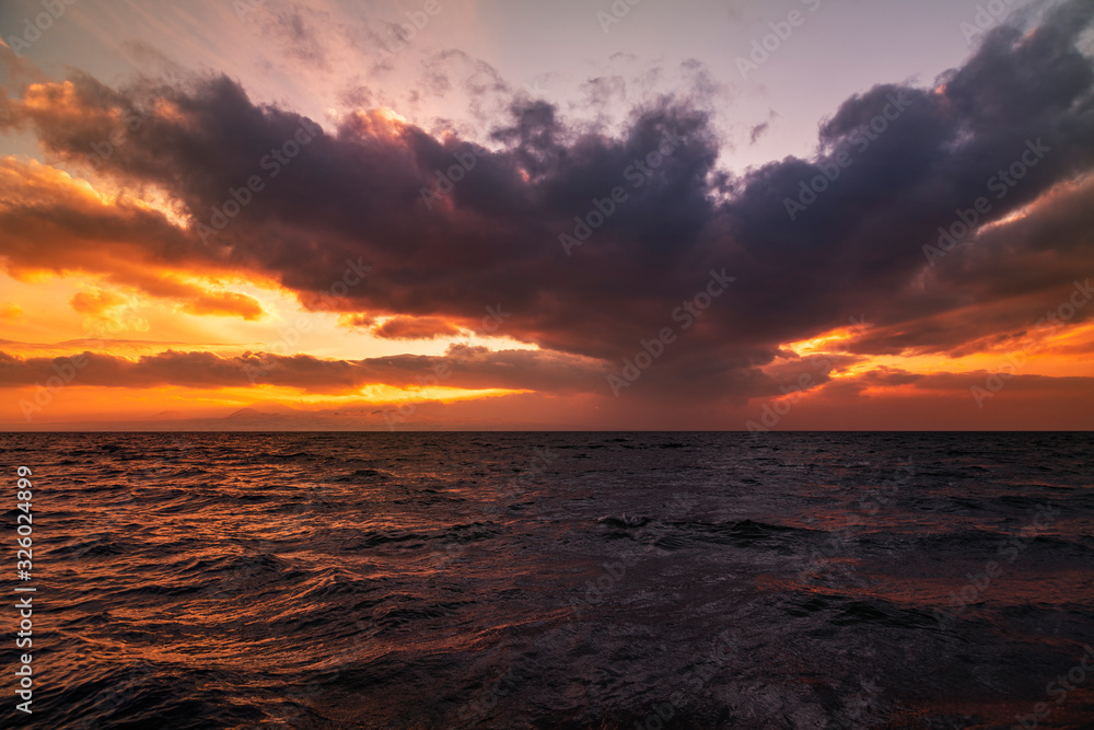 Fototapeta premium Beautiful landscape. Bright sunset with dramatics clouds over the lake. 