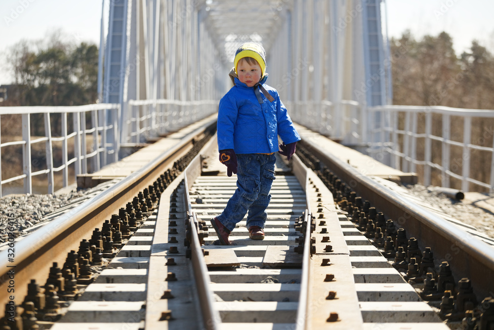 child is dangerous on the railroad tracks in spring
