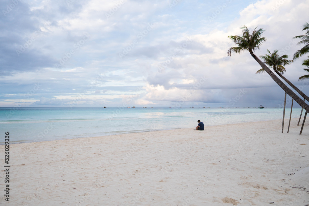 a man having his early meditation at the beach
