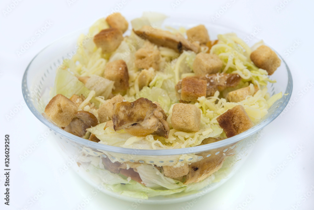 Caesar salad with toast, lettuce and grilled chicken breast and cheese Caesar salad with toast, lettuce and grilled chicken breast and cheese
