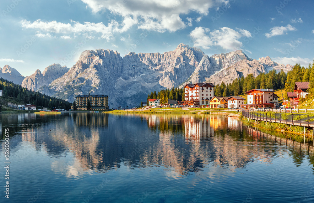Amazing tourquise Misurina lake with perfect sky reflection in calm water. Stunning view on the majestic Dolomites Alp Mountains, Italy, National Park Tre Cime di Lavaredo, Dolomiti Alps, Tyrol.